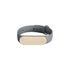 A grey wristband with a cream-coloured oval section, featuring a logo on the front.
