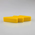 A yellow stress relief toy shaped like a lightning bolt, with a smooth, solid design.