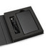 A black solid-state power bank with a USB cable, displayed in a black presentation box.
