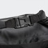 A black dry bag featuring a durable buckle and textured interior. It includes a logo on the surface.
