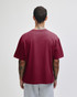 A maroon unisex boxy t-shirt viewed from the back, with a simple design and short sleeves.