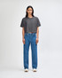 A grey heavy cotton crop boxy T-shirt worn with blue jeans, featuring a relaxed fit and short sleeves.