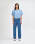 A light blue crop boxy T-shirt paired with blue jeans, worn by a model against a plain background.