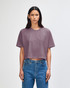A women's cropped boxy T-shirt in a muted mauve colour, featuring short sleeves and a relaxed fit. It has a logo.