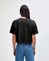 A black women's crop boxy t-shirt with a relaxed fit, featuring a simple design on the back.