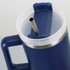 A drink bottle in navy blue with a clear lid and stainless steel straw, featuring a handle and a logo.