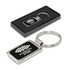 A metal key ring with a rectangular shape featuring a logo. The key ring is presented in a black box.