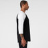 A black and white raglan t-shirt featuring three-quarter length sleeves and a logo on the chest.