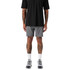 Active shorts in grey, paired with a black shirt and athletic shoes, featuring a logo on the shorts.