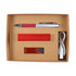 A cardstock gift box containing a silver pen with red accents, a red USB flash drive, a red power bank, and a charging cable.
