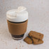 A reusable coffee cup with a white lid and cork band, accompanied by two brown biscuits on a textured surface.