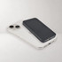 A black wireless power bank rests on a smartphone on a light background, showcasing sleek, modern design.