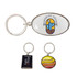 A custom-shaped metal keyring in silver, featuring an oval design with a colourful logo, alongside two smaller keyrings.