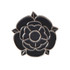 A black rose-shaped lapel pin with a silver outline and detailing, featuring an embedded logo.