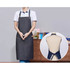 A poly-cotton denim full bib apron in dark blue, featuring a neck strap and a logo. Displayed on a model and mannequin.