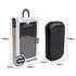 A black outdoor solar wireless power bank with green accents, displayed in its packaging.