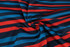 A fabric with red and blue horizontal stripes, showcasing a smooth, polyester texture.