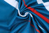 A blue polyester fabric with white and red stripes, showcasing a textured pattern suitable for sports polo shirts.