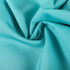 A smooth, turquoise fabric with a soft texture, suitable for clothing and apparel. It has a flowing appearance.