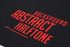A black sports short with a bold red abstract halftone design and a logo.