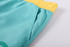 Men's polyester sublimated beach shorts in teal with a yellow waistband, featuring a pocket and a logo.