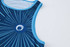 A blue sublimated singlet featuring a circular logo and a radial design pattern.