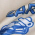 A close-up of fabric showcasing a unisex varsity jacket in cream and blue with a logo design.