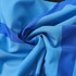 A close-up of blue polyester spandex fabric with varying shades, featuring a smooth and soft texture.