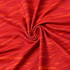 A close-up of red polyester spandex fabric with an abstract orange pattern, featuring a subtle logo.