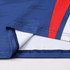 A close-up of a blue long-sleeved T-shirt featuring red and white accents, showcasing its fabric and stitching details.