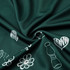 A dark green fabric featuring white illustrations of flowers, hearts, and other designs.