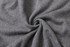 A close-up of a unisex 100% cotton round collar sweater in a soft, grey fabric, featuring a subtle texture.