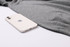 A grey unisex 100% cotton V-neck sweater beside a smartphone, featuring a logo on the phone.
