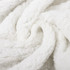 A white, fluffy blanket with a soft, textured surface, showcasing its cozy and luxurious feel.