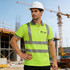 A bright green polyester polo shirt with reflective stripes, worn by a man in a hard hat at a construction site.