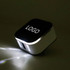 A travel adapter in black and white with USB ports and a logo on the top.