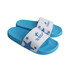 A pair of blue PVC slides with a white strap featuring a logo and star design.