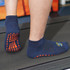 Crew Gripper Socks in navy blue with orange grip patterns on the soles, designed for better traction while active.