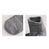 A pair of grey socks with a gripper design, featuring a close-up view of the toe and cuff sections.
