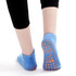 A pair of blue low cut kids' gripper socks, featuring orange non-slip grips on the soles.