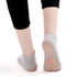 A pair of low cut grey kids' gripper socks featuring non-slip orange grips on the soles.