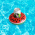 A watermelon-themed inflatable cup holder with a can in the centre, set against a blue water background.