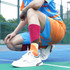 Mid calf custom pattern socks in vibrant red, orange, and yellow, worn with white sneakers on a sports court.