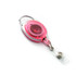 A retractable oval card holder in pink with a silver clip, featuring a clear attachment for securing cards.