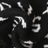 Acrylic fibres scarf featuring a black and white design, showcasing a textured knit pattern.