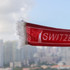 A red scarf with white fringe and a logo, featuring a suction cap on one end.