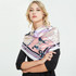 A silk satin scarf featuring a stylish design in shades of pink and purple, adorned with intricate patterns.