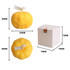Pumpkin-shaped candles in vibrant yellow, featuring a carved face, packaged in a small white box.