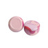 Two pink tin candles with a decorative design, featuring a logo on the lid.