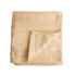 A folded bamboo fibre towel in a light beige colour, featuring a textured surface and a woven band detail.
